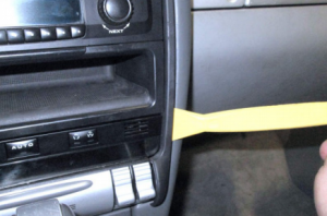 Pry out the trim piece along the perimeter of the center dashboard with a lever